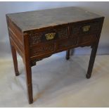 A 19th Century Chinese Side Table with two drawers above three carved panels raised upon square