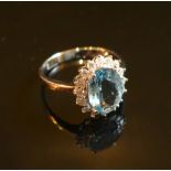 A White Gold Oval Aquamarine and Diamond Cluster Ring, approximately 1.86 / 0.38 ct.