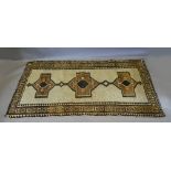 A North West Persian Woollen Rug with an all over design upon a cream and beige ground within