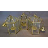 A Set of Three Brass Hexagonal Lanterns with Six Glass Panels,