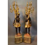A Pair of Blackamoor Floor Standing Six Branch Candelabrum with scroll sconces above figural