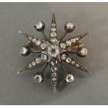 A White Gold Diamond Set Brooch in the form of a Star with central diamond surrounded by diamonds,