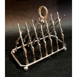 A Silver Plated Six Division Toast Rack in the form of Rifles