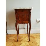 A 19th Century French Bedside Cabinet with a variegated marble top above a drawer and cupboard door