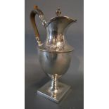 A Birmingham Silver Covered Jug with shaped handle and square pedestal base bearing engraved crest,