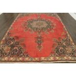 A North West Persian Woollen Carpet, with an all over design upon a red,