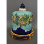 A Majolica Cheese Dish and Cover decorated in relief with a foliate design upon a dark blue and