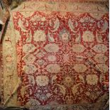 A Large Early Agra Carpet with an allover design upon a red and cream ground within multiple