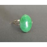 An 18ct White Gold Ring set Large Oval Cabochon Jade Stone flanked by Diamonds