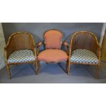 A 20th Century French Armchair with a Padded Back and Seat raised upon cabriole legs with scroll