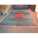 A Gabbeh Woollen Carpet with a central medallion upon a blue and red ground within multiple borders,