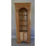 A 19th Century Pine Standing Corner Cabinet with a moulded dentil cornice above a shell carved arch