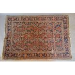 A North West Persian Woollen Rug with an all over design upon a blue and red ground within multiple