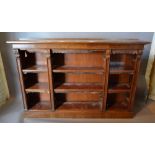 A 19th Century Rosewood Dwarf Bookcase with an arrangement of shelves and applied scroll carvings