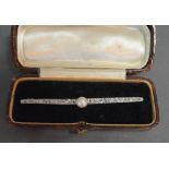 A White and Yellow Gold Long Bar Brooch set with a central pearl and many diamonds, 7.