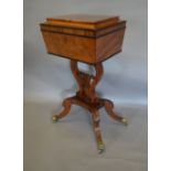 A Regency Mahogany Teapoy, the hinged cover enclosing a fitted interior above a lyre support,