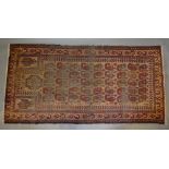 A North West Persian Woollen Rug with an all over design upon a red ground within multiple borders,