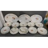 A Berlin Porcelain Dinner Service comprising plates, bowls and three meat platters,