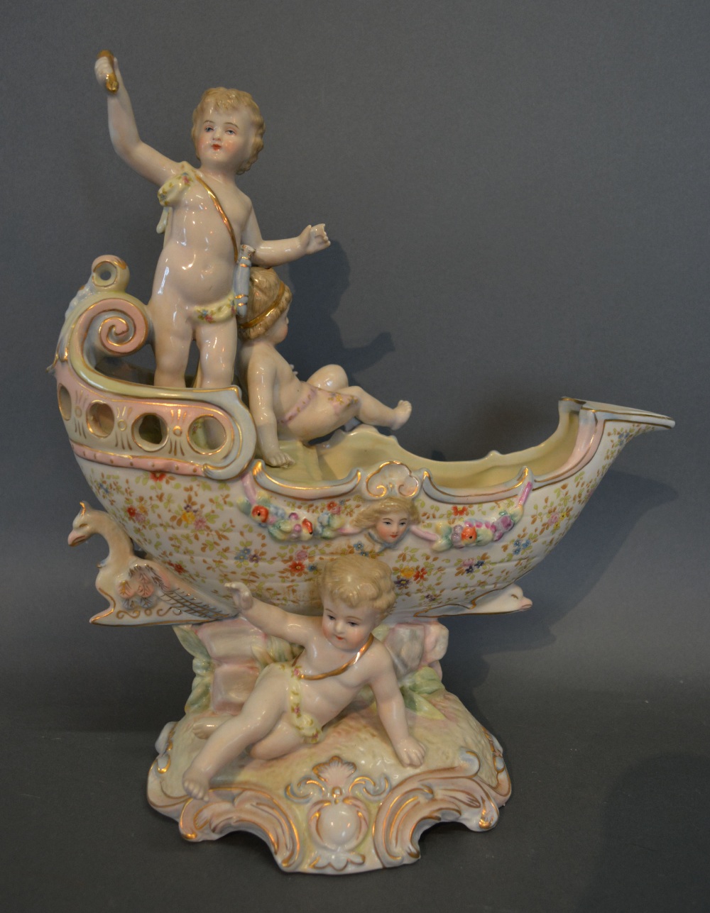 A German Porcelain Comport of Scroll Shaped Form, with figural surmount,