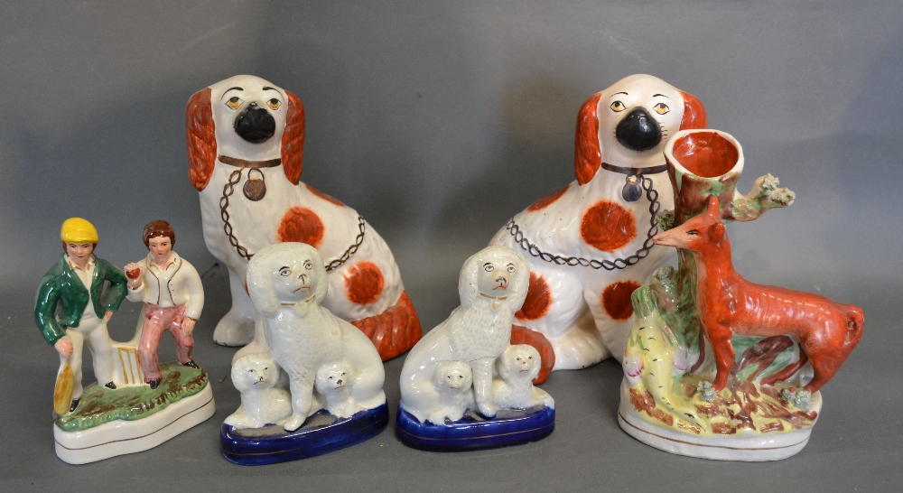 A Pair of Staffordshire Models of Spaniels together with a similar smaller pair of Staffordshire