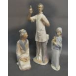 A Lladro Porcelain Figure in the form of a Doctor together with a Lladro porcelain figure of a girl