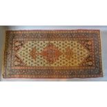 A North West Persian Woollen Rug with a central medallion within an all over design upon a cream,