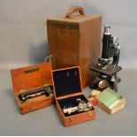 A Beck Black Japans Microscope with original box and accessories to include slides