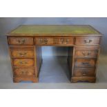 A Reproduction Mahogany Twin Pedestal Desk with a green tooled leather inset top above nine drawers