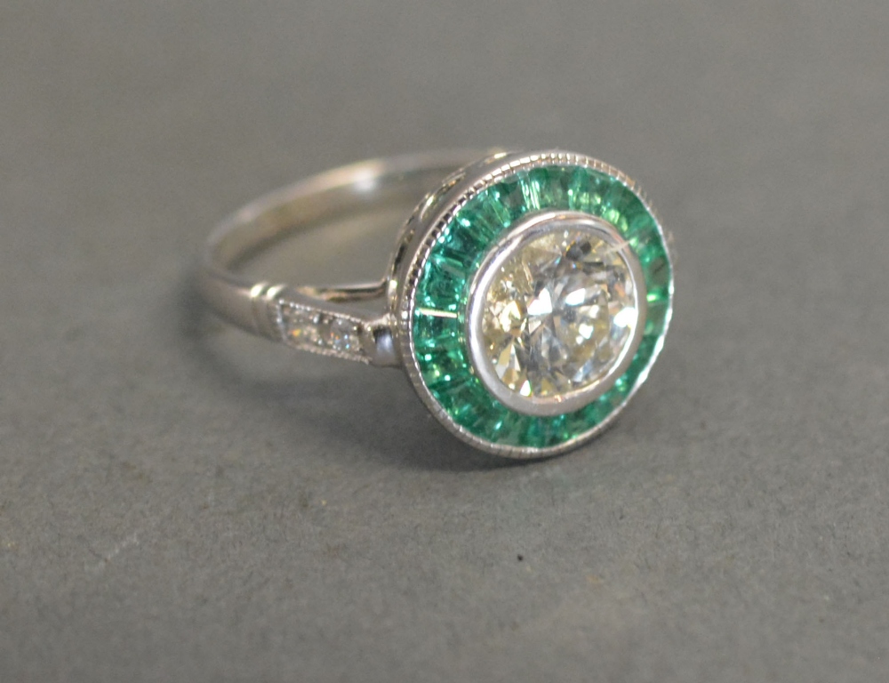 A 14ct White Gold Emerald and Diamond Ri