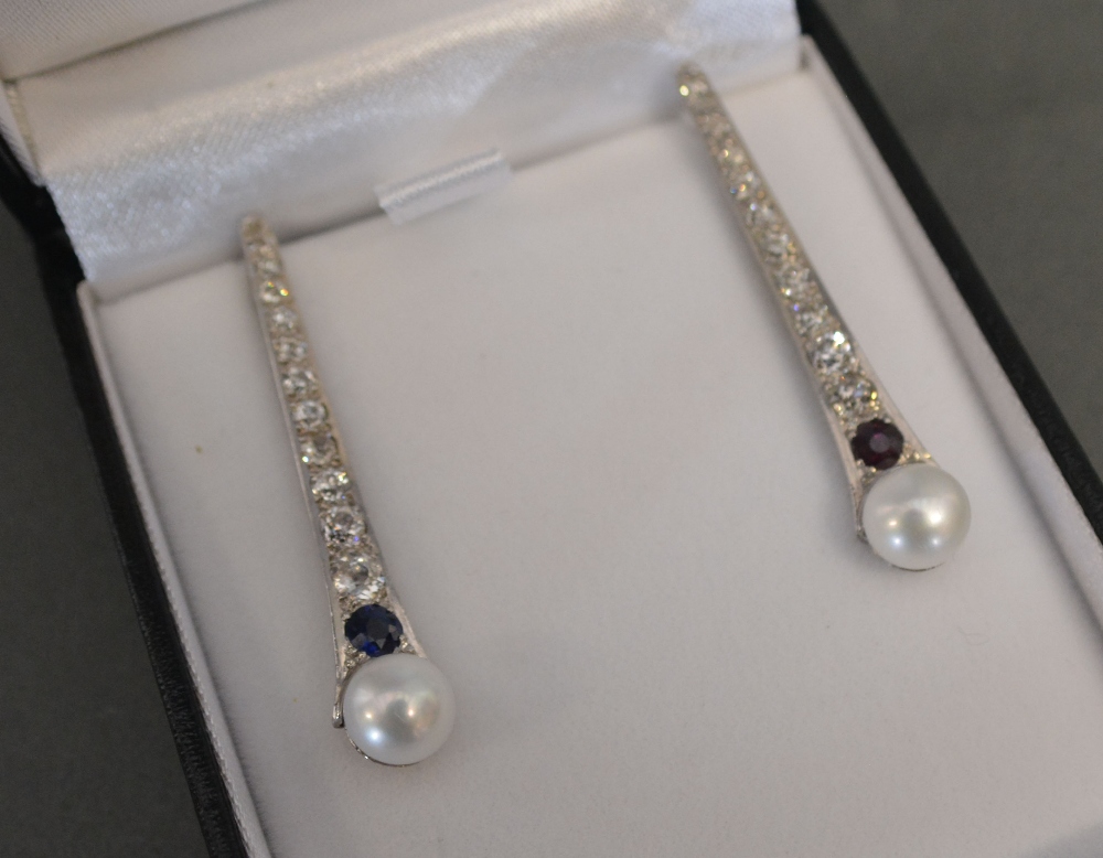 A Pair of White Gold Diamond and Pearl Drop Earrings, one set with a sapphire,