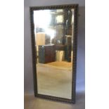 A Rectangular Oak Wall Mirror with Bevelled Plate Glass,