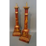 A Pair of Toll Ware Chinoiserie Decorated Table Lamps each with gilded decoration upon a red ground