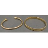 A 9ct. Gold Bangle, 23.2 gms, together with a 14ct. gold bangle, 7.