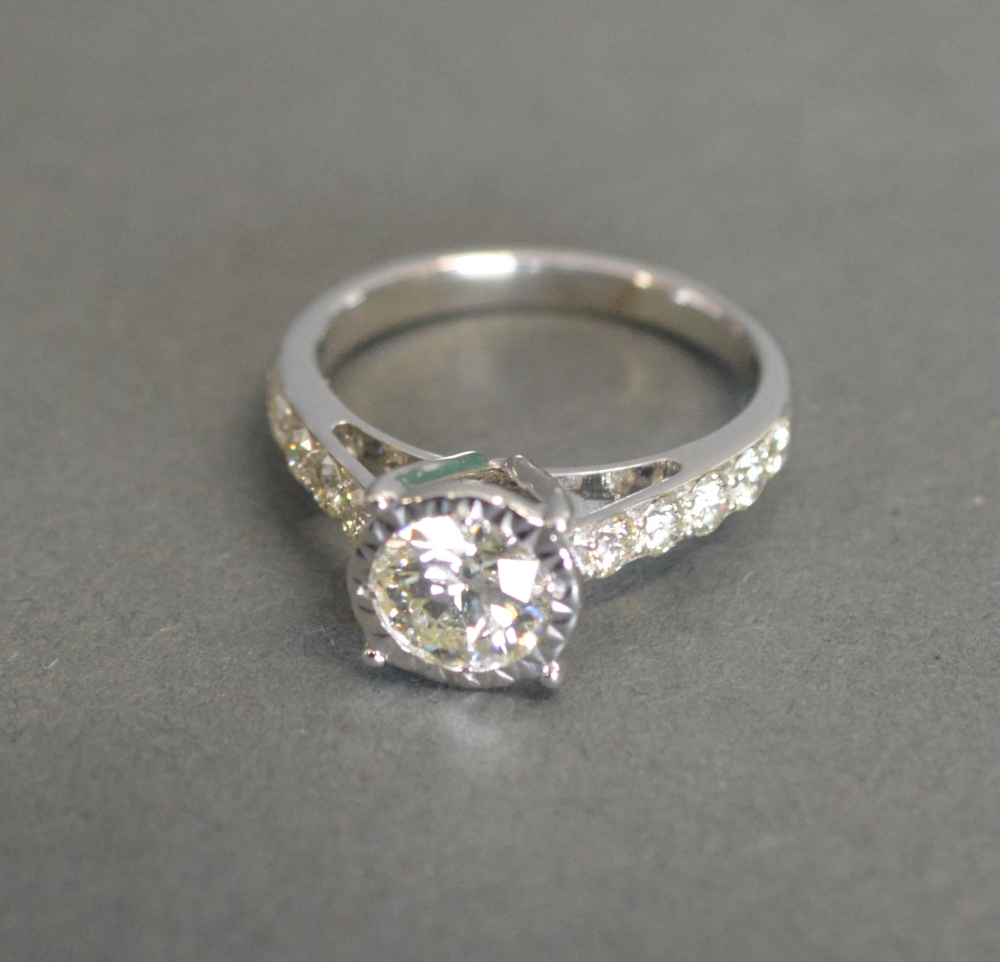 An 18ct White Gold Solitaire Diamond Ring with Diamond Shoulders, solitaire 0.