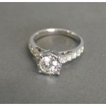 An 18ct White Gold Solitaire Diamond Ring with Diamond Shoulders, solitaire 0.