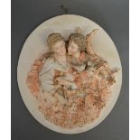 A German Bisque Wall Plaque of Oval Form, decorated in relief with classical figures with birds,