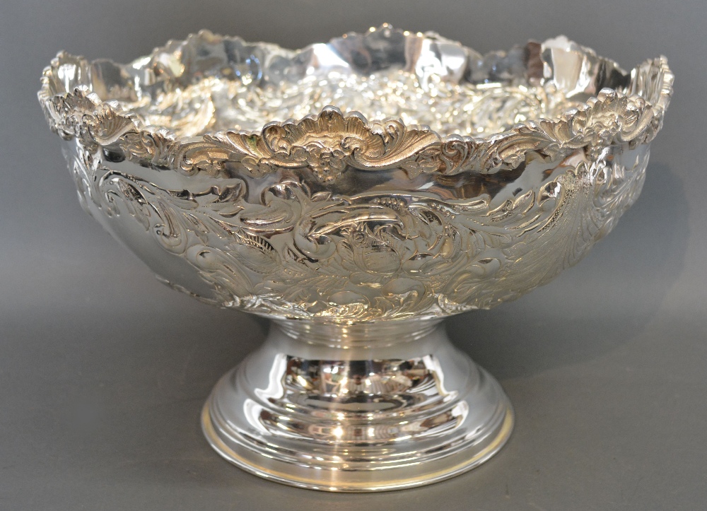 A Large Silver Plated Punch Bowl with embossed decoration and circular pedestal base,