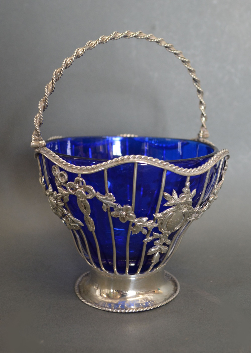 A George III Silver Basket of Pierced Foliate Form with Birds Amongst Foliate and Rope Twist Handle