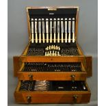 An Art Deco Twelve Place Setting Canteen of Cutlery with a hinged top above two fitted drawers