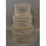 A Graduated Set of Three Cut Glass Cylindrical Covered Boxes,