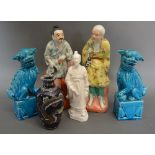 A Pair of Chinese Porcelain Models of Tradesmen, together with a pair of blue glazed Dogs of Fo,