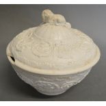 An Early Wedgwood Cream Ware Covered Bowl, decorated with embossed scrolls and with dog surmount,