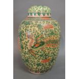 A 19th Century Chinese Covered Jar decorated in polychrome enamels with an exotic bird amongst