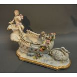A German Porcelain Vase in the form of a Chariot mounted with Putti and Swan,