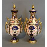 A Pair of Royal Crown Derby Porcelain Two Handled Covered Vases in the Imari Palette,