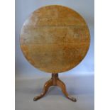 A George III Oak Pedestal Table with a circular top above a turned centre column and tripartite