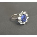 An 18ct White Gold Sapphire and Diamond Cluster Ring with a central sapphire surrounded by diamonds,