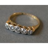 An 18ct Yellow Gold Five Stone Diamond Ring with five graduated diamonds within a pierced setting