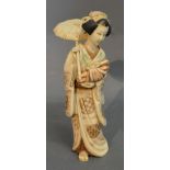 A Late 19th Early 20th Century Japanese Carved Ivory Okimono in the form of a girl with parasol,