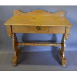 A 19th Century Pine Washstand with a frieze drawer raised upon shaped end supports with stretcher